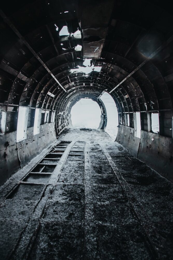 Disused old grey aircraft with snow on floor